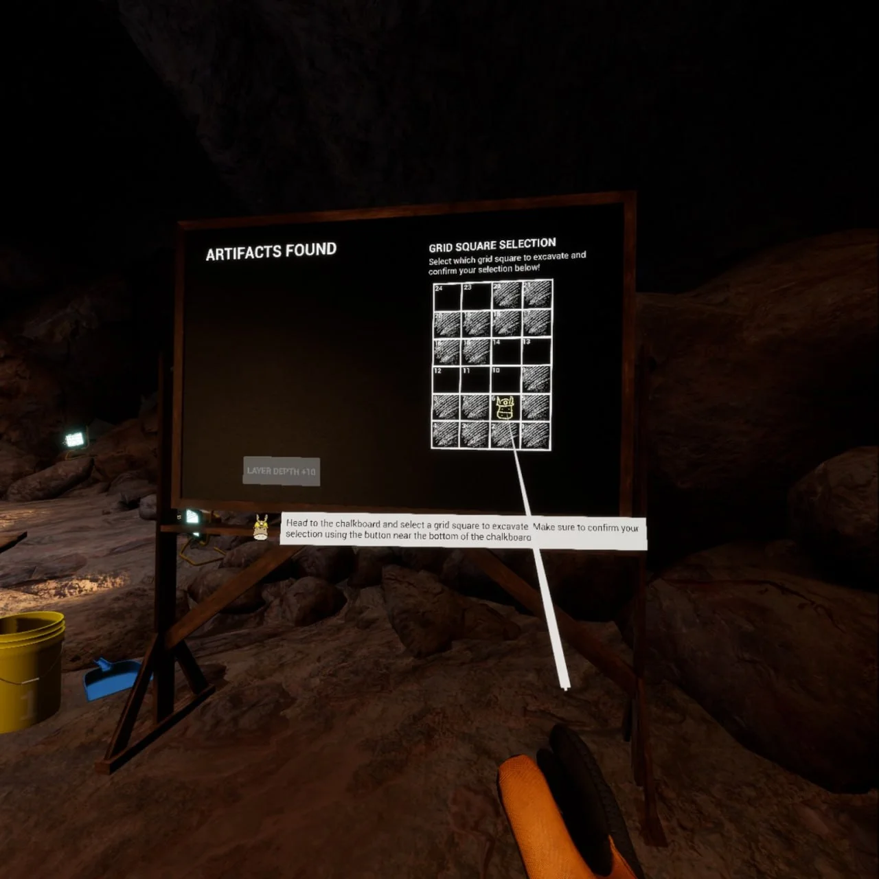 A virtual pointer selects a square on a numbered excavation grid; the board also has an Artifacts found area and instructions to confirm a selection.